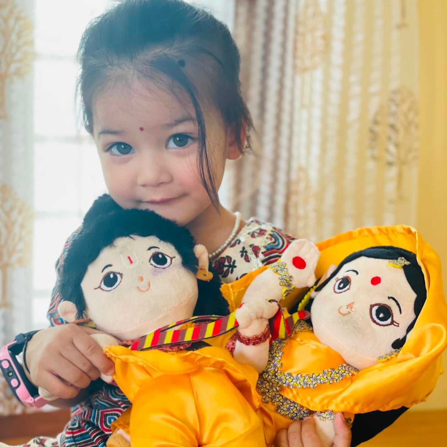 A baby girl with baby rama & devi sita