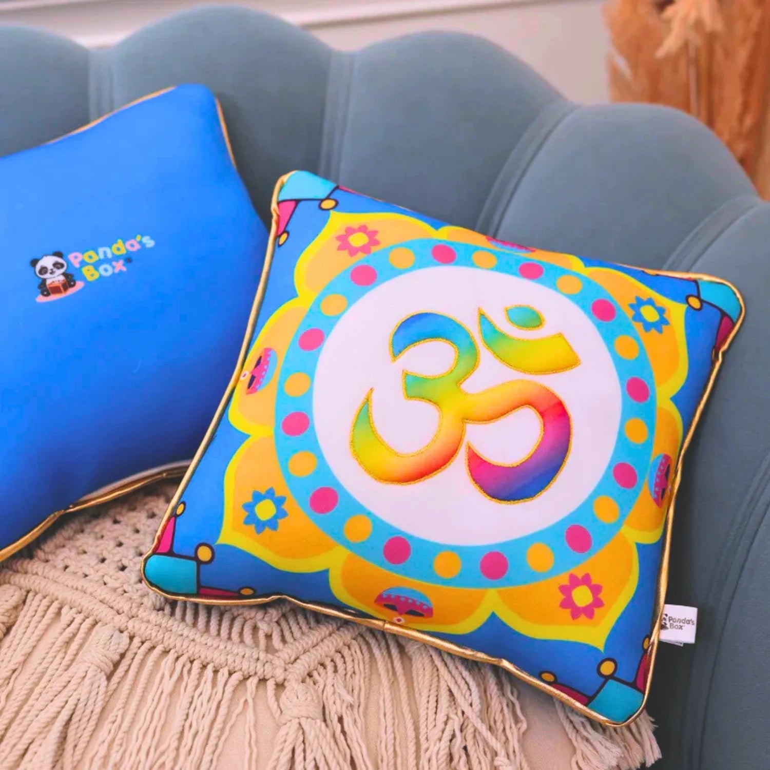 Colorful pillow with Om symbol on a blue couch